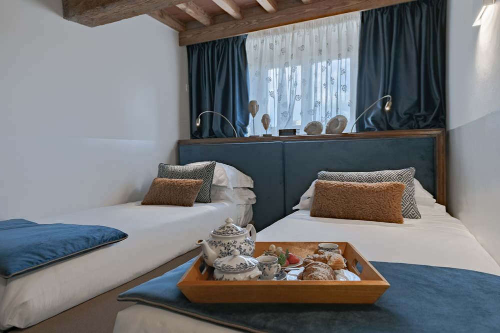 Cozy bedroom detail with double bed and soft lighting