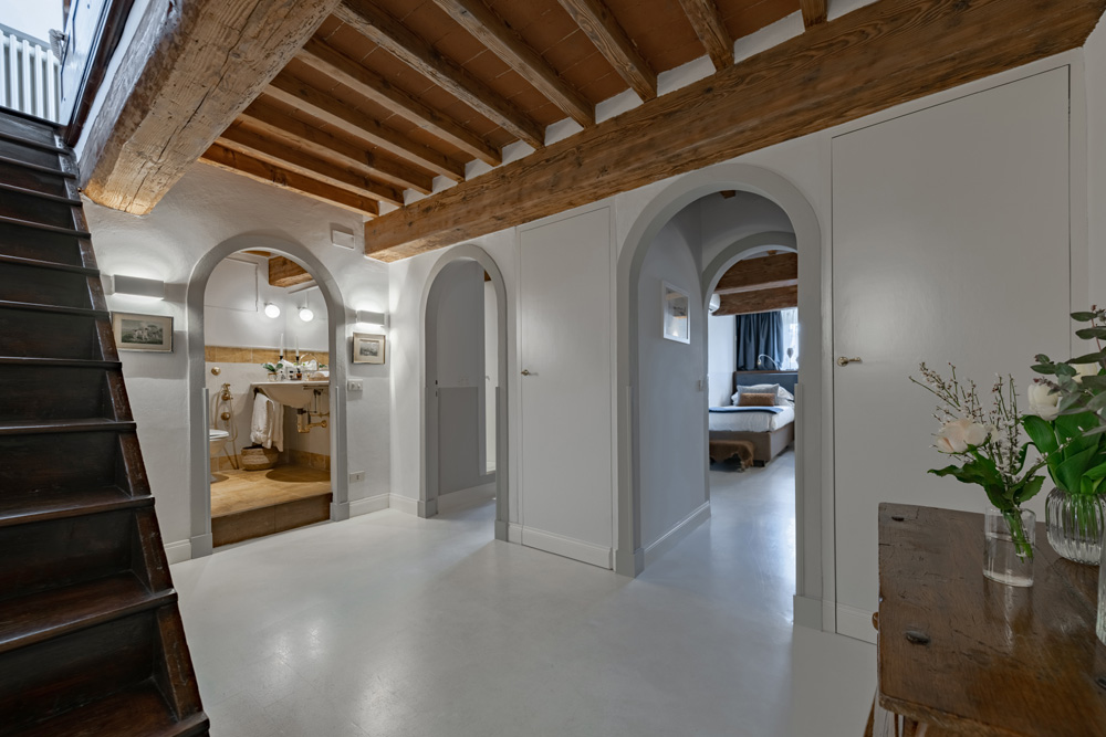 Bright living area with arches and wooden ceiling in luxury apartment