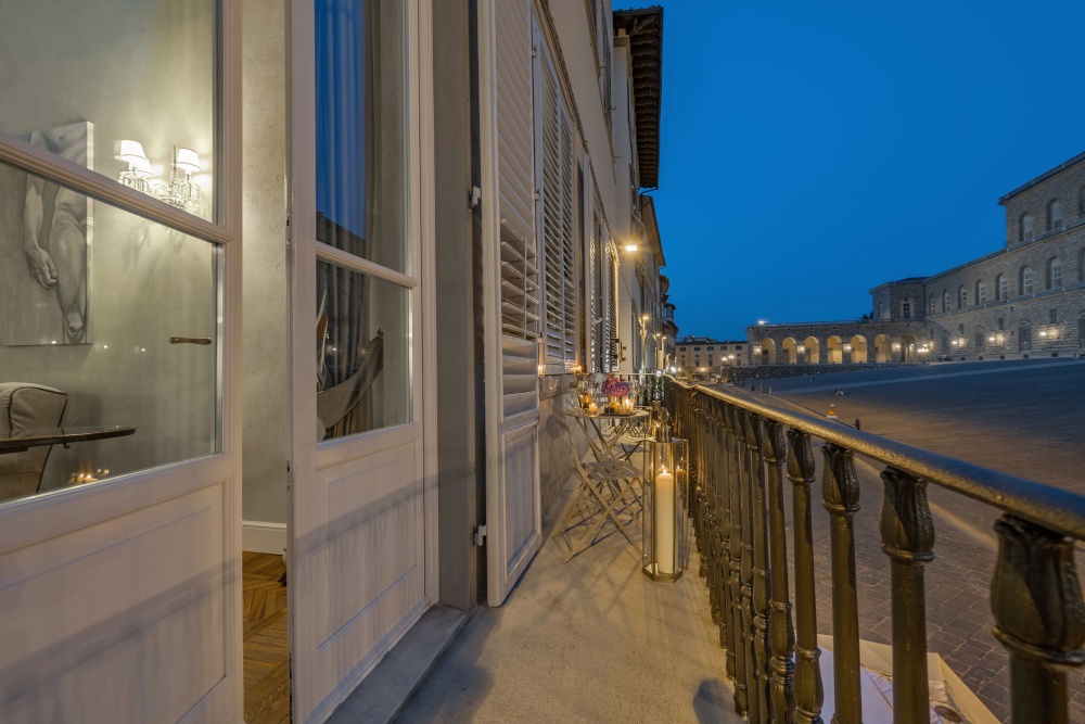 Balcony doorway with evening view over Piazza Pitti in Florence