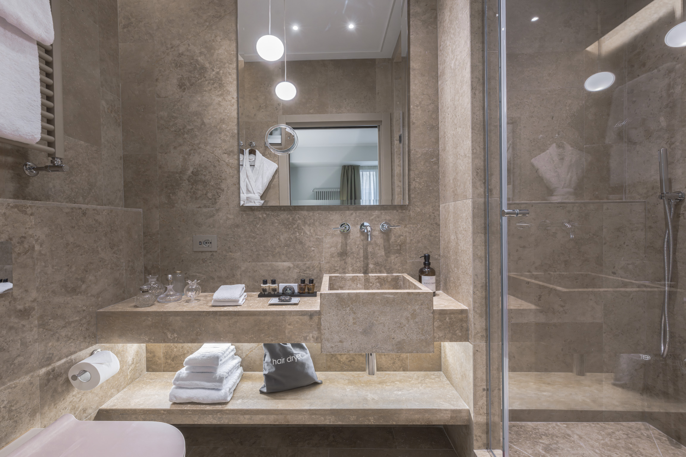 Marble bathroom with walk-in shower in Florence apartment