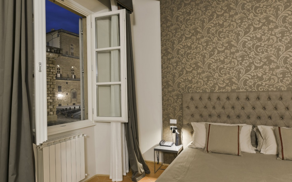 bedroom with classic wallpaper in Florence apartment