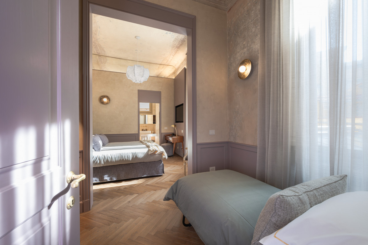 Bedroom entrance with natural light in Medici apartment in Florence