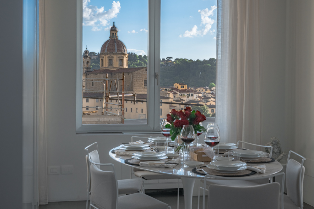 Dining area of the Casamanda penthouse with a view over the rooftops of Florence