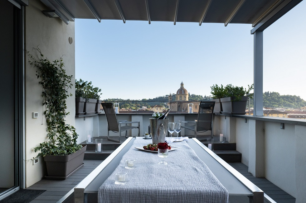 Wide terrace with seating area and open sky view