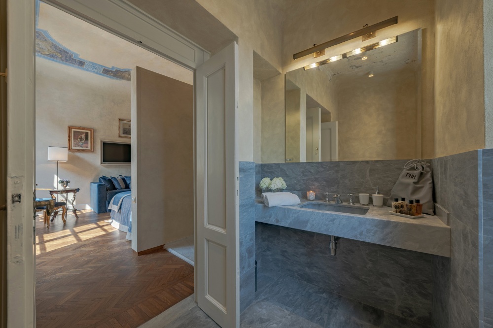 En-suite bathroom vanity with marble finishes in Florence luxury apartment