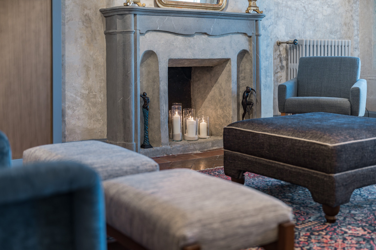 Lounge area with fireplace in historic Florence apartment