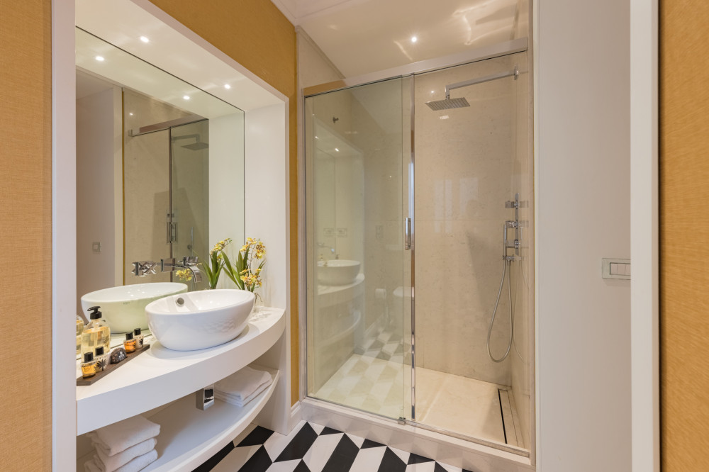 Bathroom with glass shower in Florence apartment