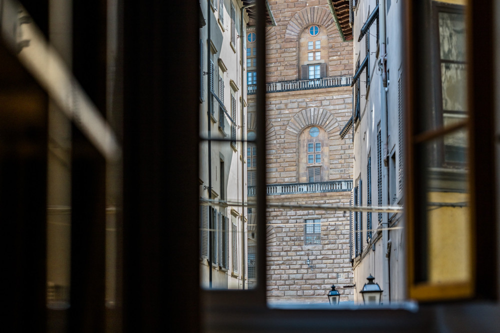 Window view of historic building from Florence apartment