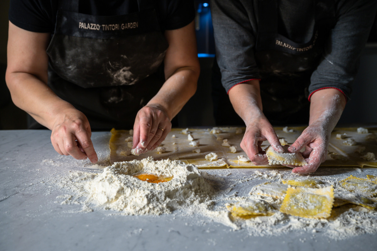 Hands preparing homemade pasta during private cooking class in Florence