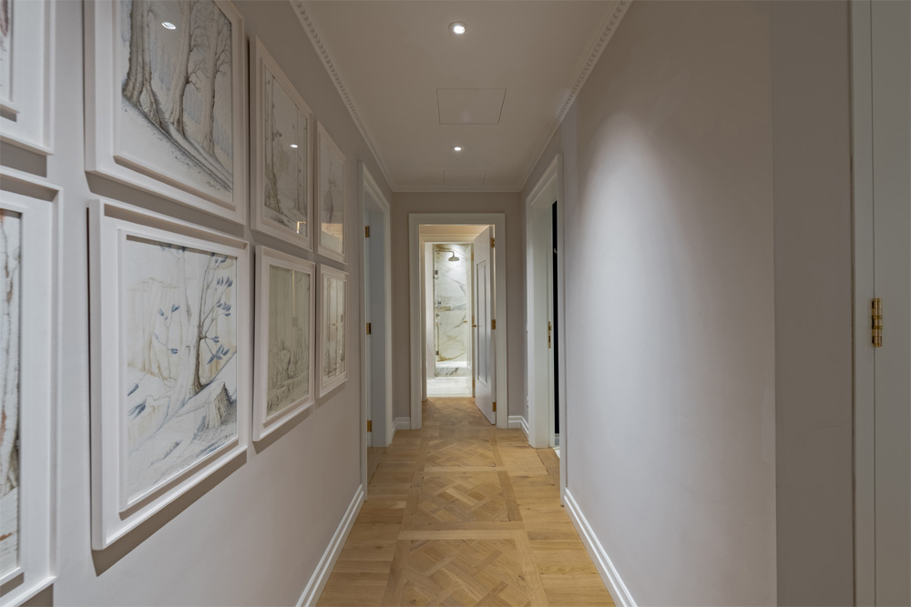 Elegant hallway with framed artwork in Unicko apartment in Florence