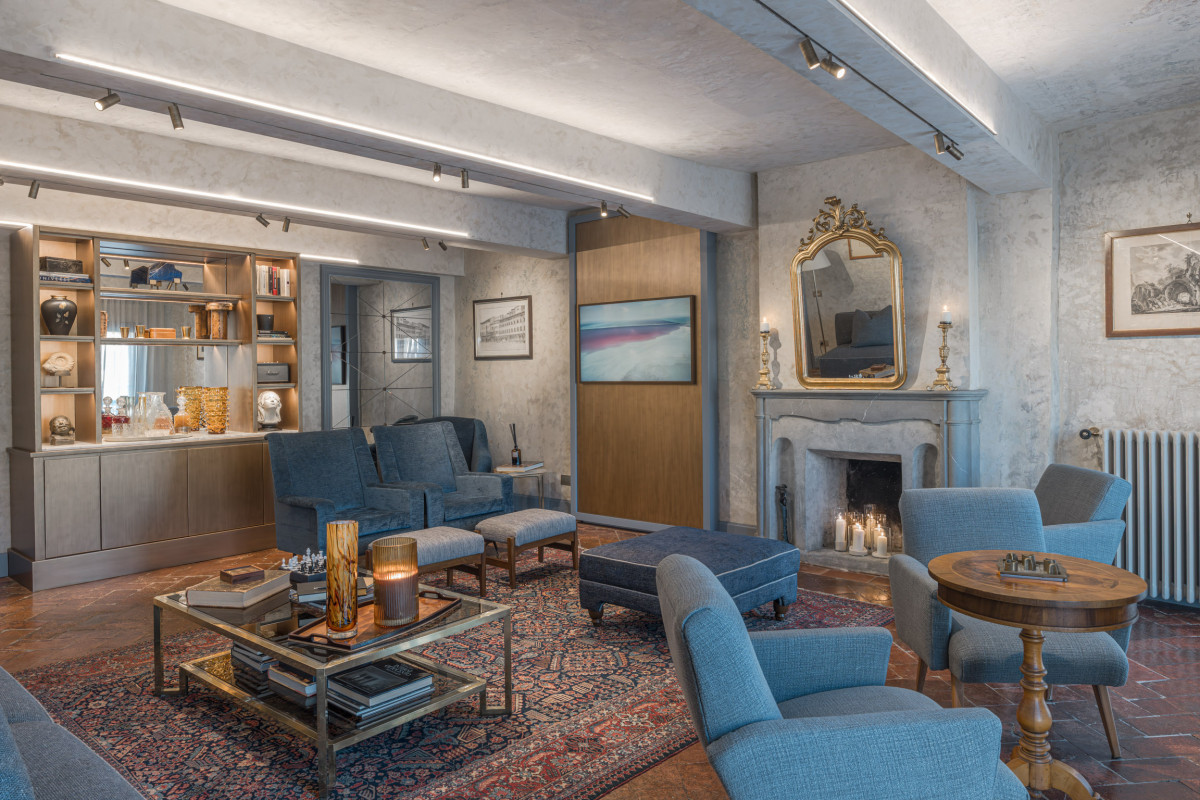 Historic living room with fireplace in Santa Croce apartment Florence