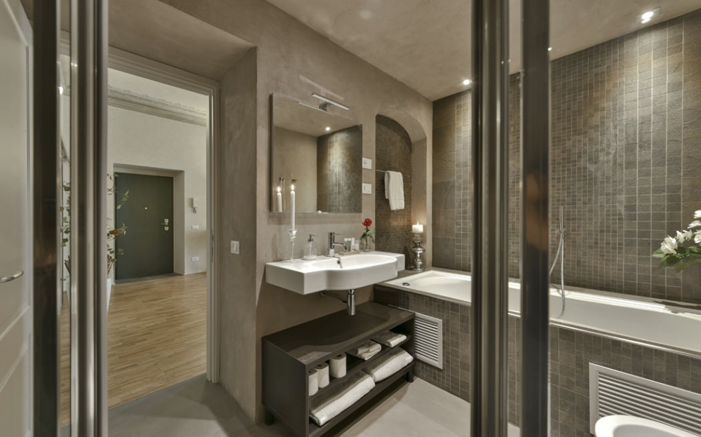 Modern luxury bathroom with bathtub and elegant finishes in historic apartment near Piazza Pitti Florence