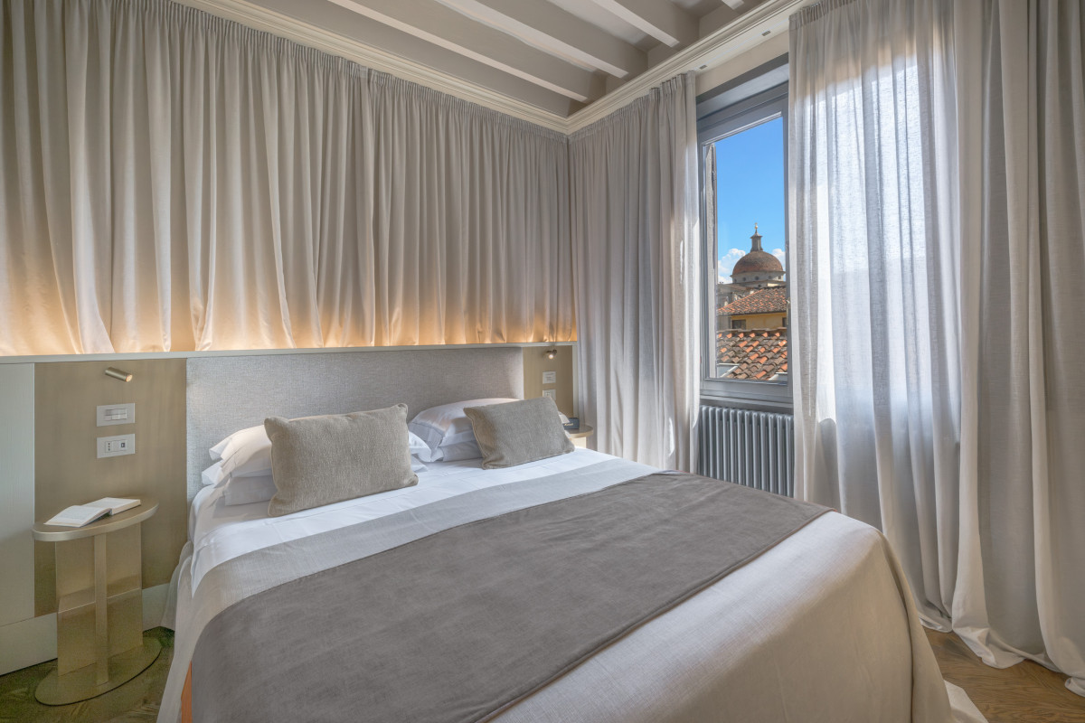 Bedroom in Florence apartment with soft lighting