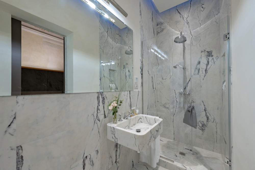 Marble bathroom with large walk-in shower in Florence apartment