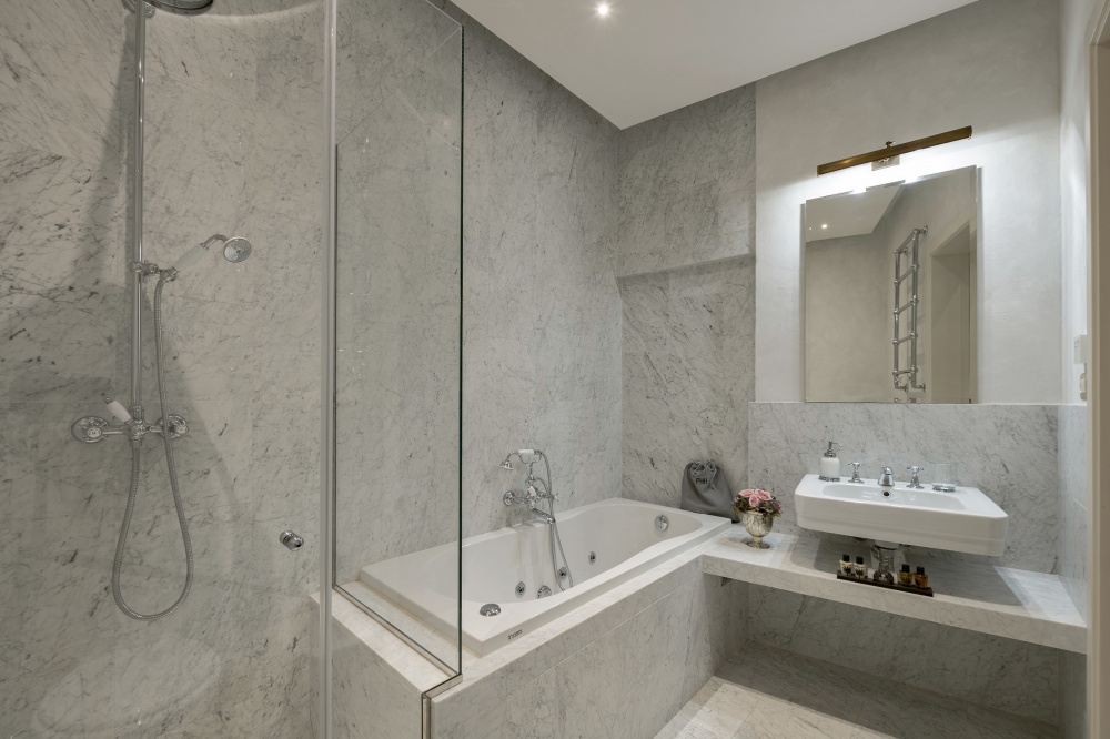 Marble bathroom with walk-in shower and bathtub in Pitti Historical Home
