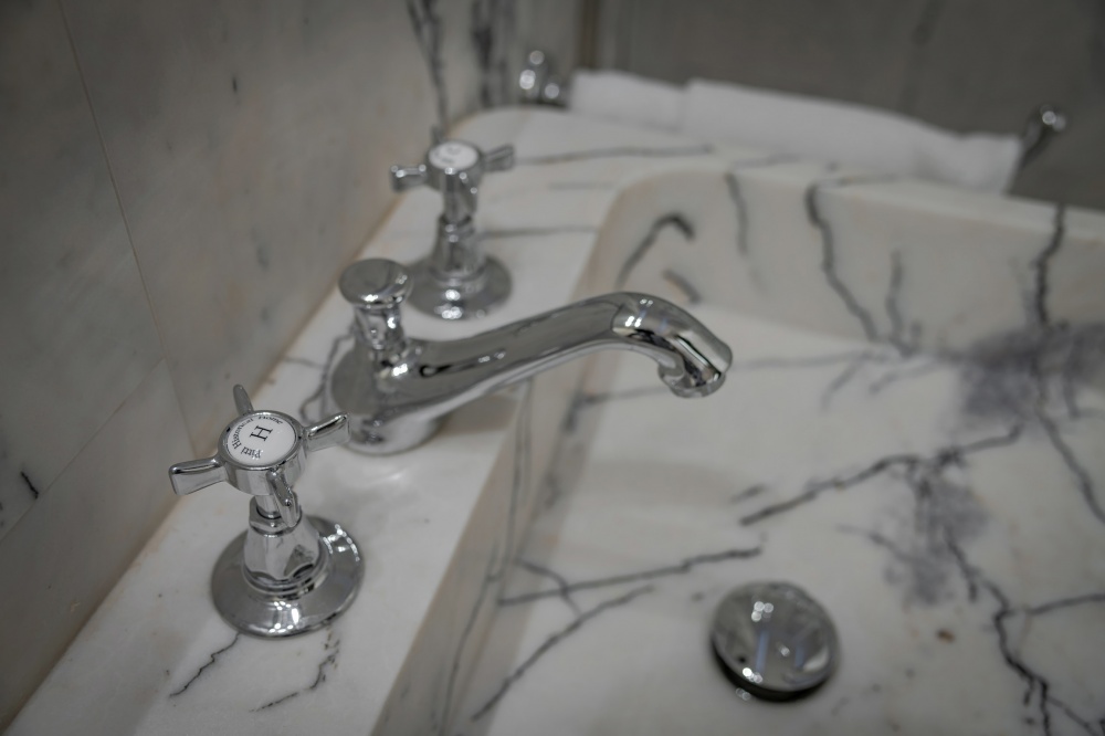 Marble sink and classic tap detail in luxury bathroom Florence