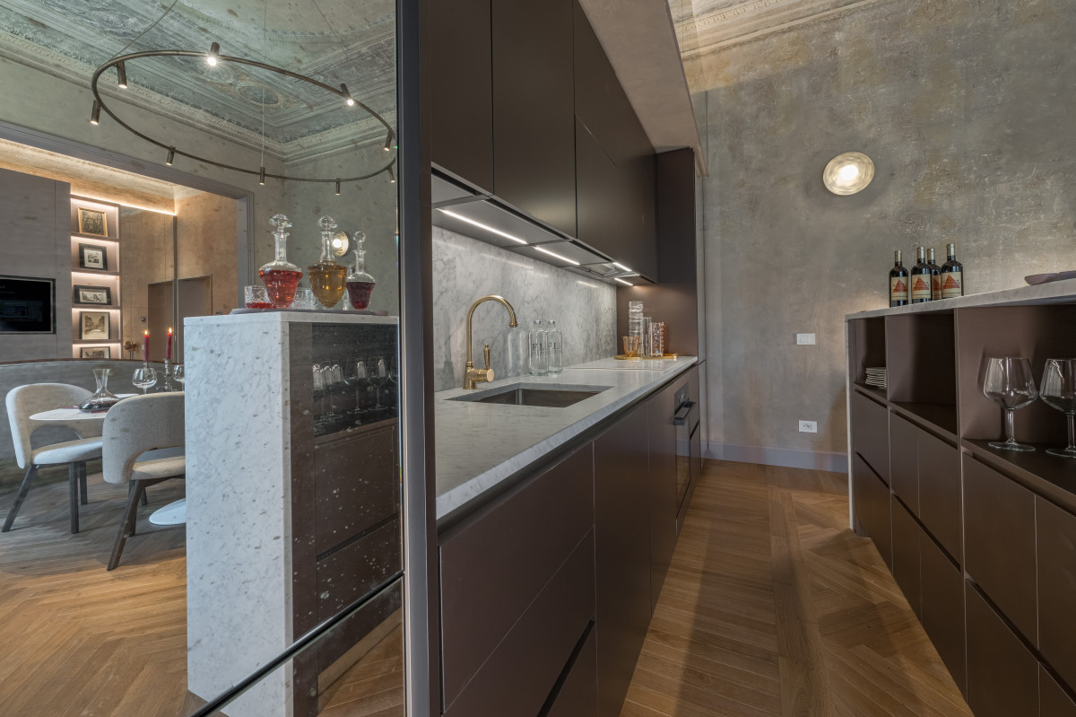 Kitchen in Medici Historical Home apartment in Florence with marble island, modern appliances and elegant design