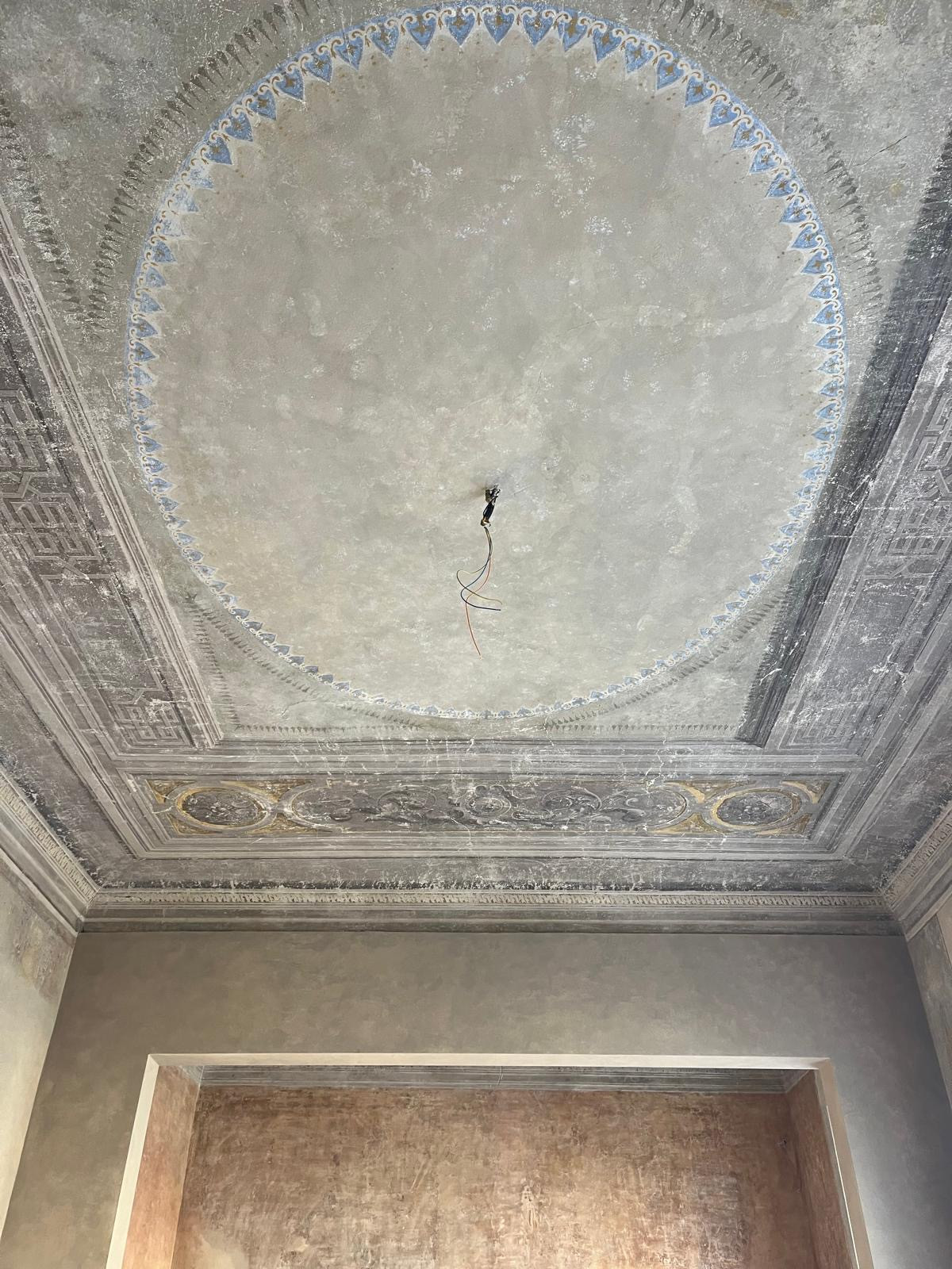 Restored ceiling fresco detail in Florence historic apartment