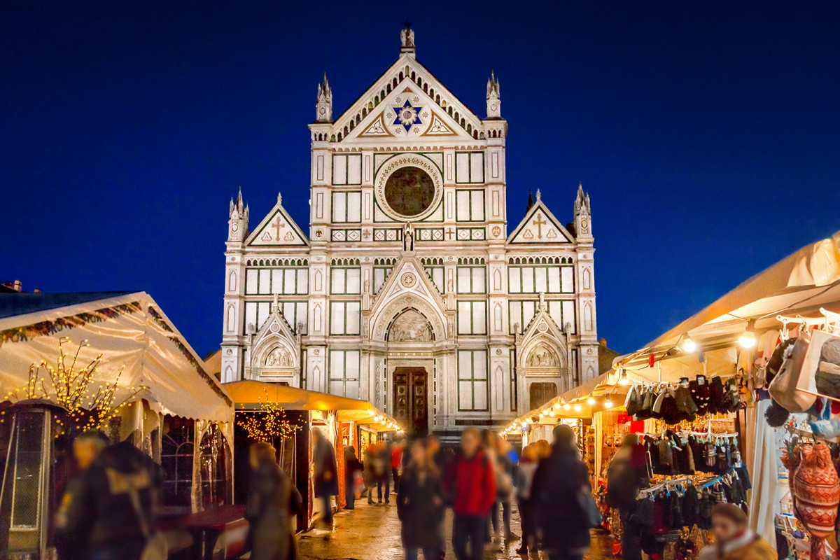 Santa Croce Basilica at night with market in Florence