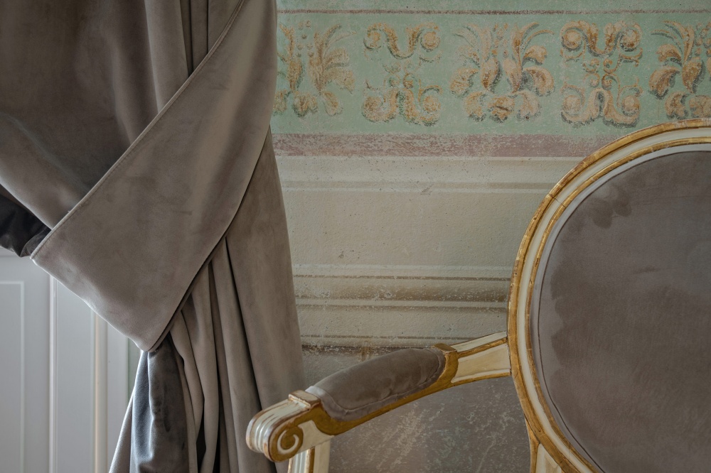 Upholstered chair detail in historic luxury apartment in Florence
