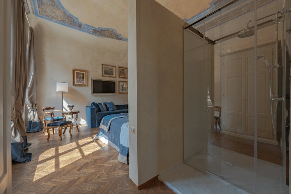 Walk-in wardrobe beside bedroom suite in luxury Florence apartment
